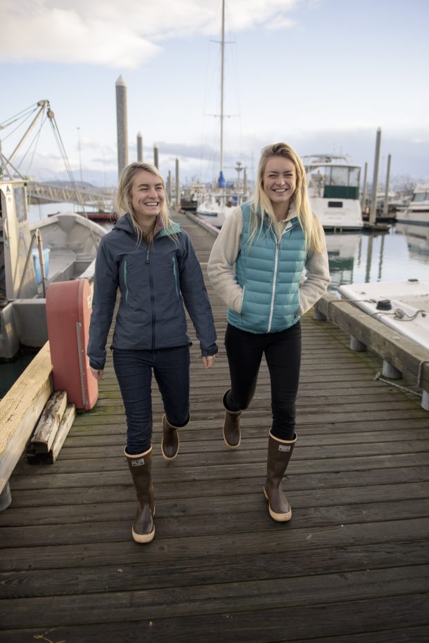 Emma Teal Laukitis and Claire Neaton,  owners Salmon Sisters, an ocean inspired brand based in Alaska. Products include apparel with custom artwork, Alaskan seafood and other handcrafted goods. Emma designed the original artwork while Claire manages the business side of the company.