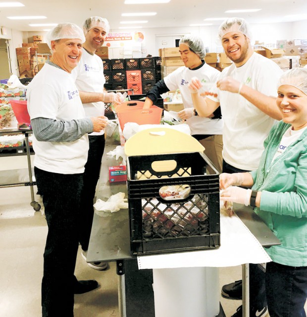 Wolverine Worldwide employees prep after-school meals at Kids’ Food Basket in Grand Rapids, MI. 